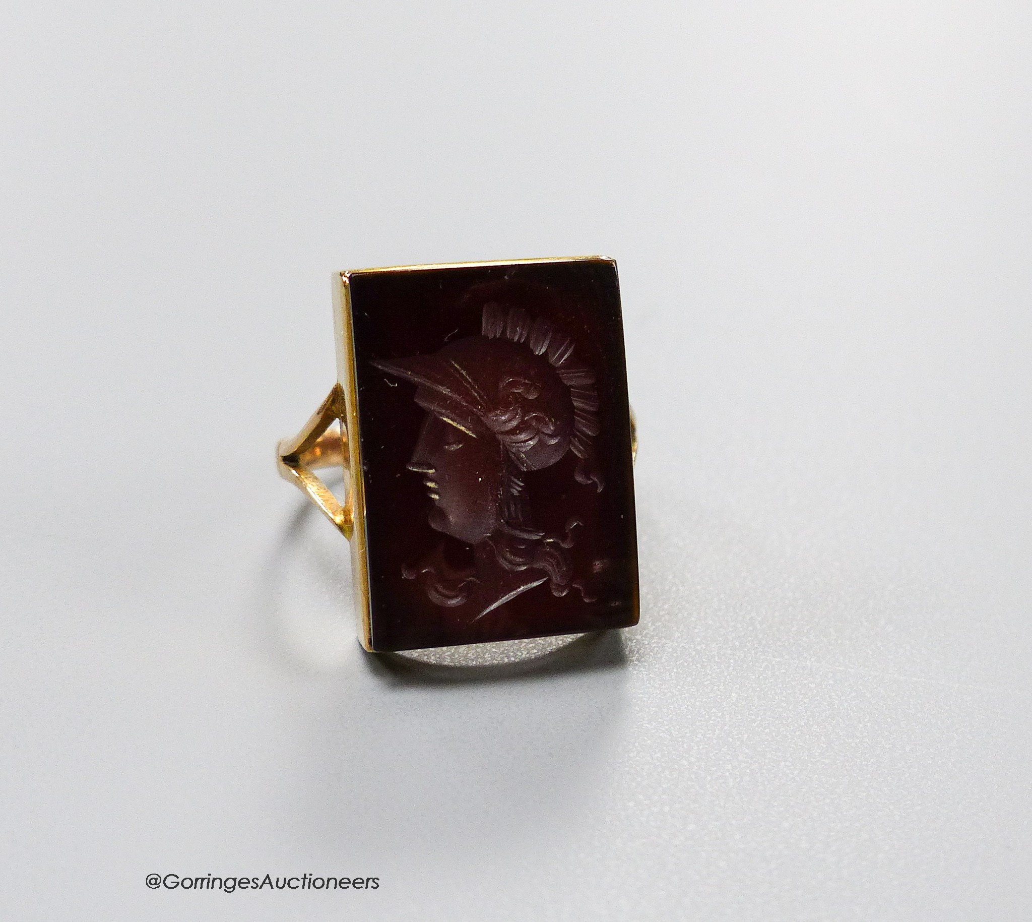 A 9ct yellow metal and intaglio hardstone signet ring, carved with the bust of a Roman soldier, size M, gross 4.1 grams.